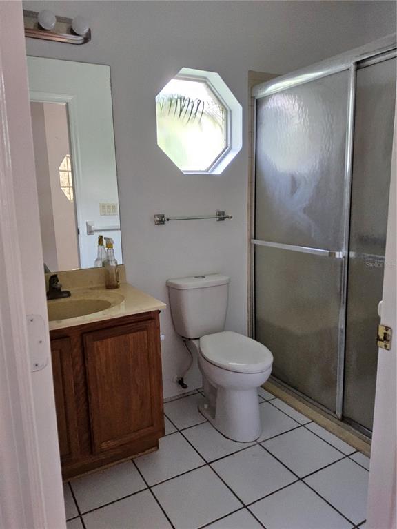 8023 St Andrews Way Mount Dora, FL 32757 - Photo 7 of 28 a bathroom with a granite countertop sink toilet and shower