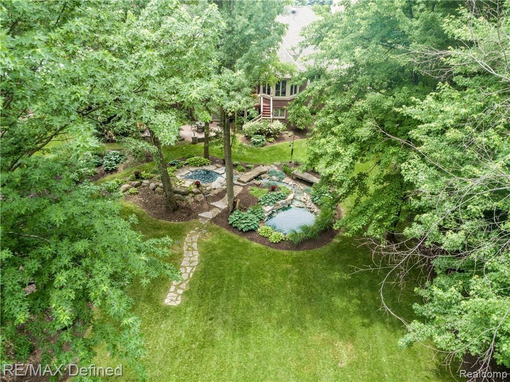 5637 Kirkridge Trail Rochester, MI 48306 - Photo 30 of 36 Beautiful grounds, waterfall and pond with room enough for a soccer field!