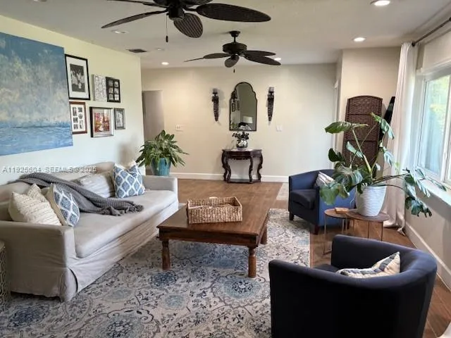 a living room with furniture and a potted plant