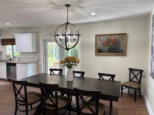 a view of a dining room with furniture wooden floor and chandelier
