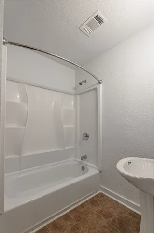a bathroom with a washer and a shower