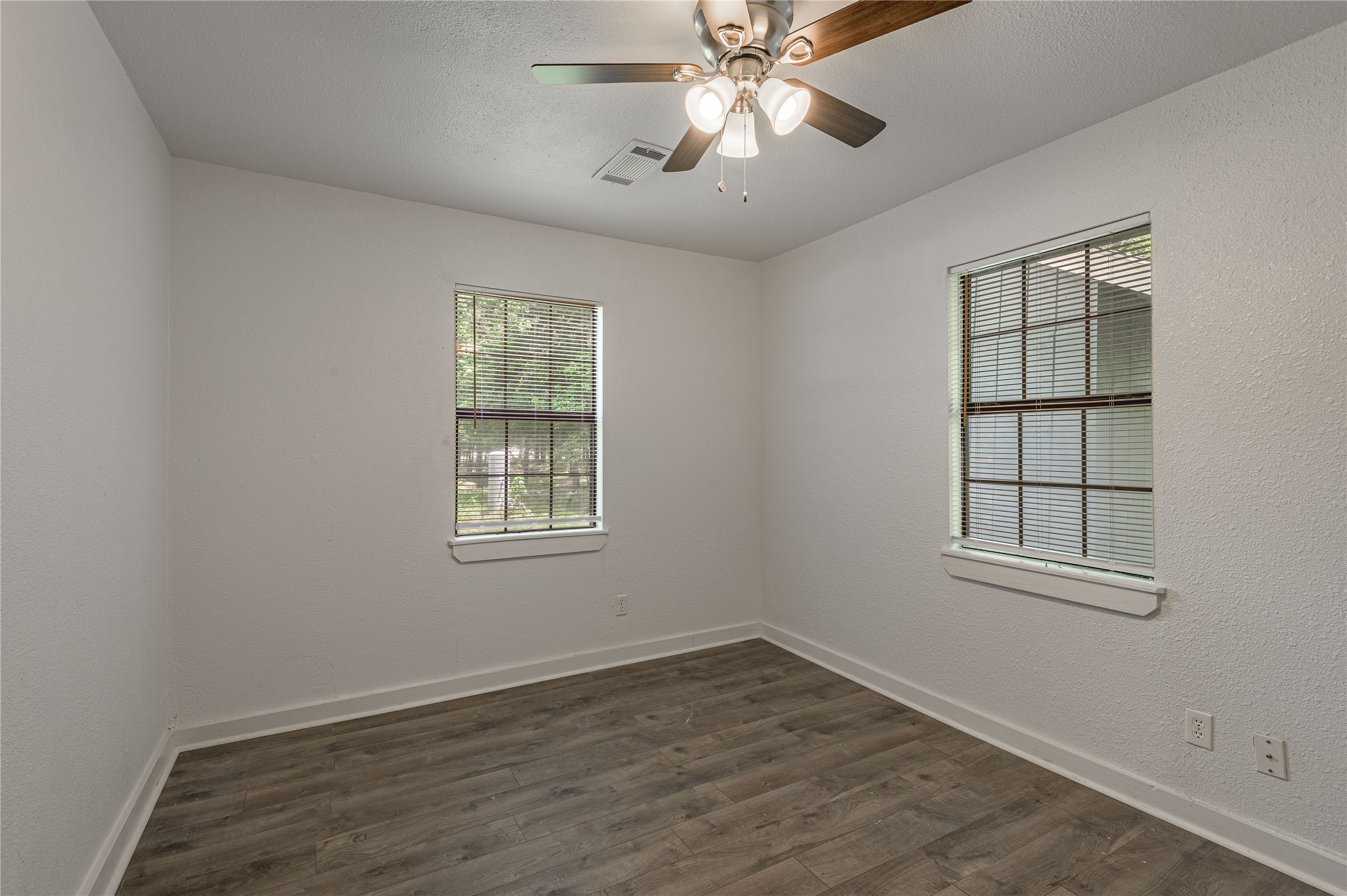 7 A Hickory Lane Huntsville, TX 77340 - Photo 17 of 36 an empty room with wooden floor closet and windows