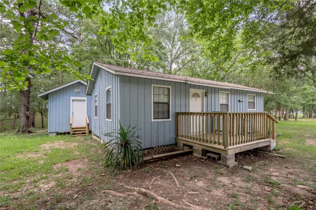 a view of backyard with a garden and deck