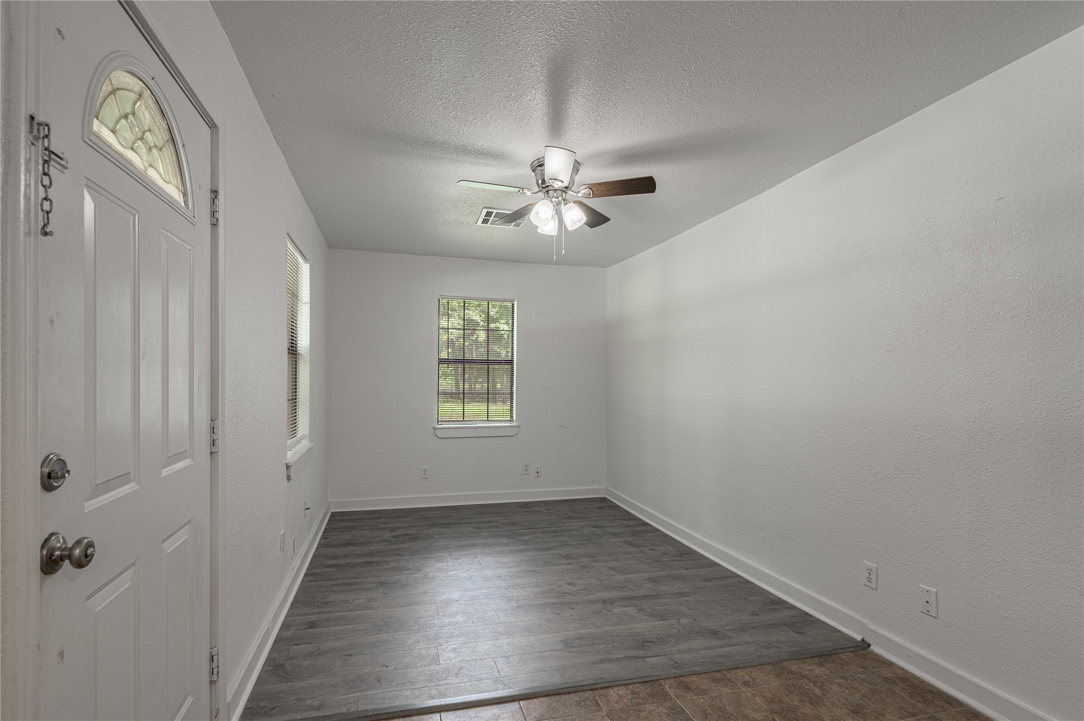 7 A Hickory Lane Huntsville, TX 77340 - Photo 5 of 36 wooden floor in an empty room with a window