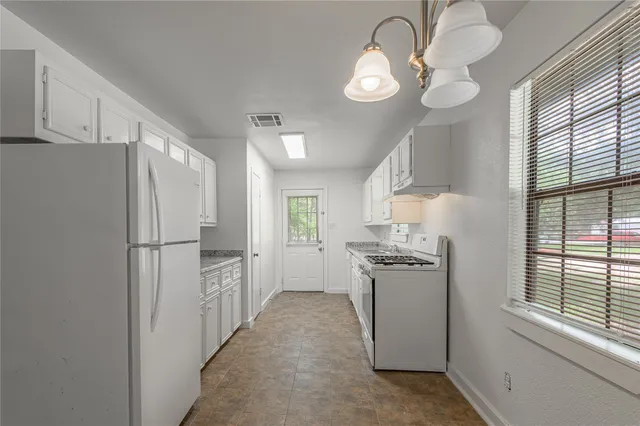 a kitchen with a refrigerator a stove top oven a sink and dishwasher