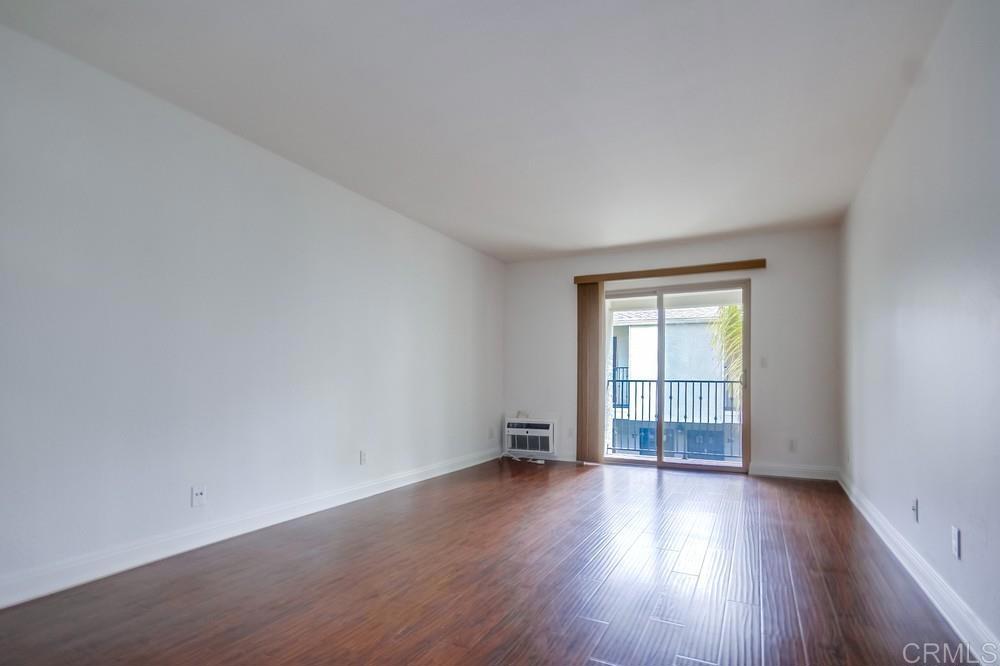 1045 Peach Avenue, Unit 12 El Cajon, CA 92021 - Photo 14 of 29 an empty room with wooden floor and windows