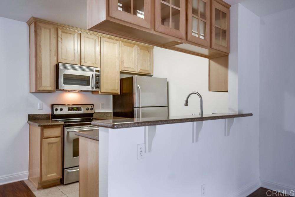 1045 Peach Avenue, Unit 12 El Cajon, CA 92021 - Photo 17 of 29 a kitchen with stainless steel appliances granite countertop a stove a sink and a microwave