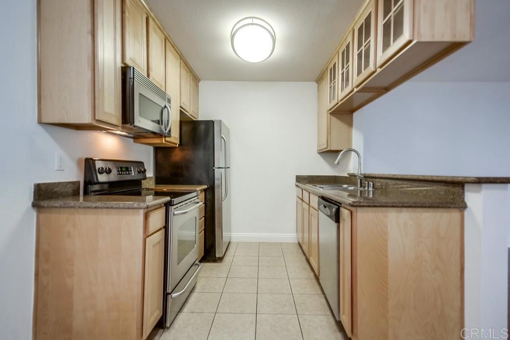 1045 Peach Avenue, Unit 12 El Cajon, CA 92021 - Photo 18 of 29 a kitchen with stainless steel appliances granite countertop a refrigerator a stove and a sink