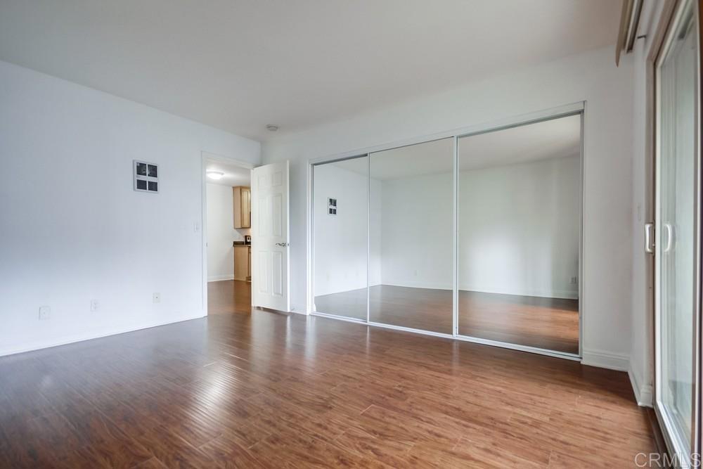 1045 Peach Avenue, Unit 12 El Cajon, CA 92021 - Photo 22 of 29 a view of an empty room with wooden floor and a window