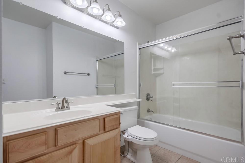 1045 Peach Avenue, Unit 12 El Cajon, CA 92021 - Photo 25 of 29 a bathroom with a sink a toilet a mirror and shower