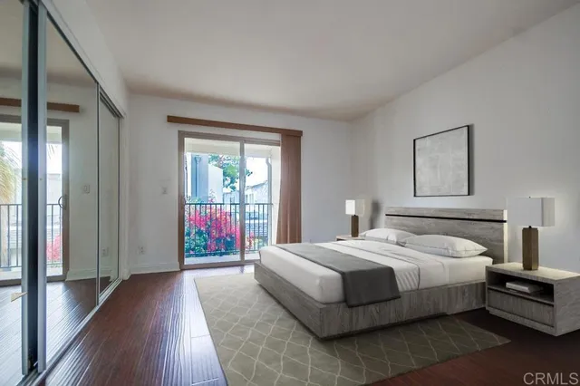 a bedroom with a balcony a bed and wooden floor