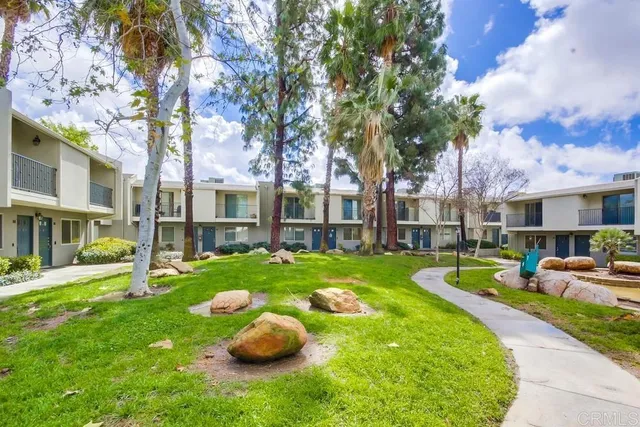 a view of a house with backyard and sitting area