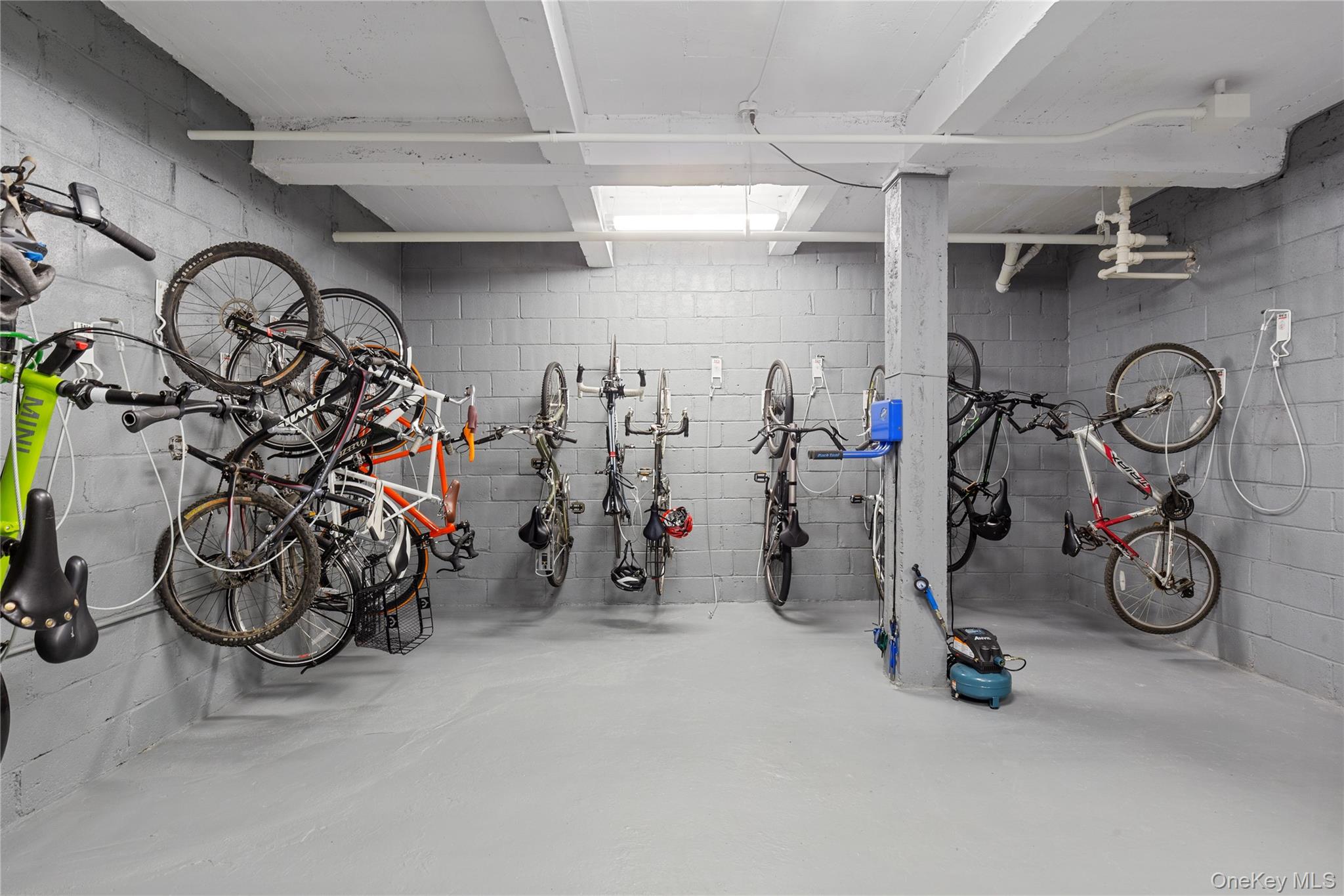 73-12 35th Avenue, Unit D44 Queens, NY 11372 - Photo 16 of 17 Garage with bike storage and concrete block wall