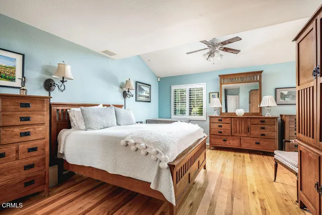 a bedroom with furniture and large windows