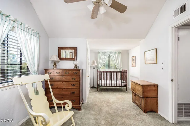 a bedroom with furniture and a flat screen tv