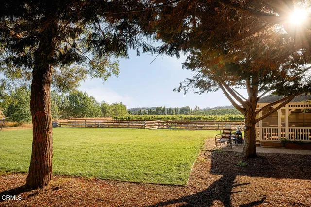 a view of a patio with dining table and chairs
