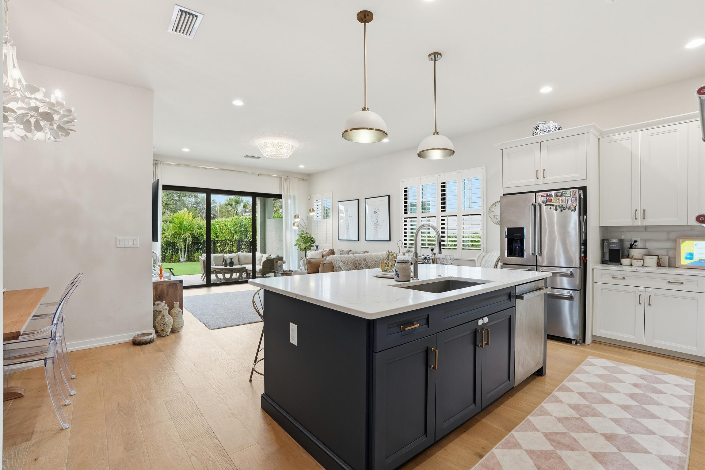 14708 Kingfisher Loop Naples, FL 34120 - Photo 13 of 42 a kitchen with a sink stove and refrigerator