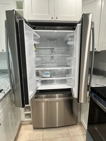a refrigerator freezer sitting inside of a kitchen