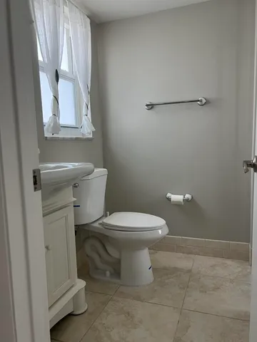 a white toilet sitting next to a bathroom sink