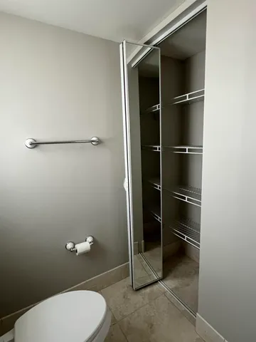 a bathroom with a toilet and a shower