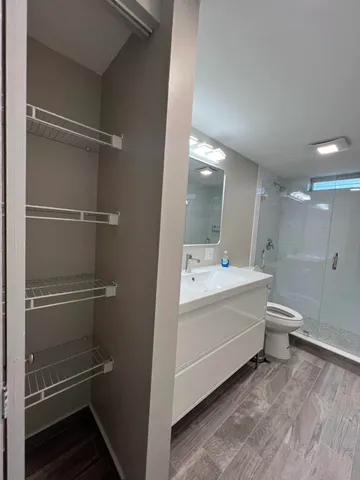 a view of bathroom with a toilet sink and mirror
