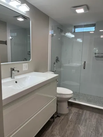 a bathroom with a sink toilet and shower