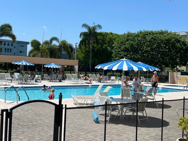a view of a swimming pool with outdoor seating