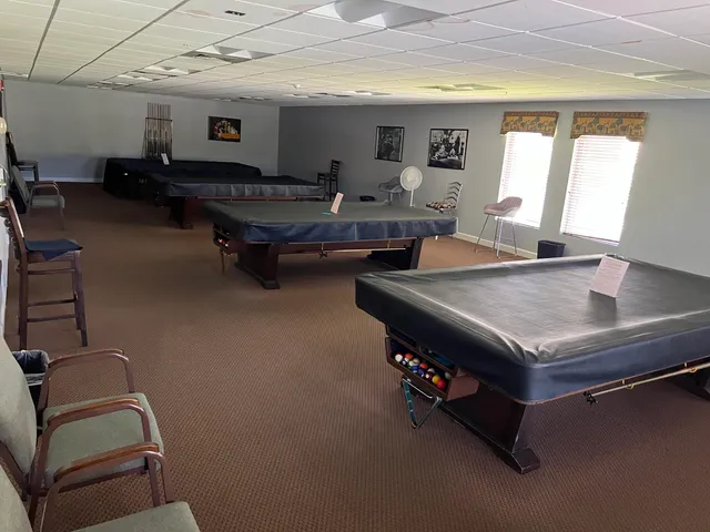 a room with pool table and windows