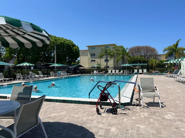 a view of swimming pool with outdoor seating and a potted plants