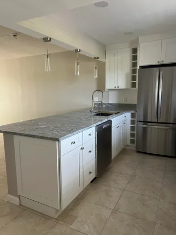 a kitchen with a stove a sink and a refrigerator