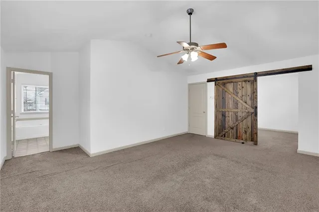 a view of a livingroom with a ceiling fan and window