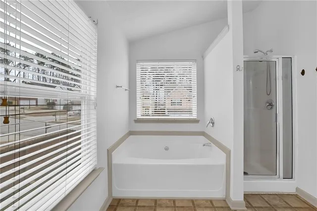 a bathroom with a double vanity sink a mirror and a bathtub