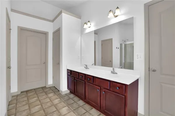 a bathroom with a sink double vanity and a mirror