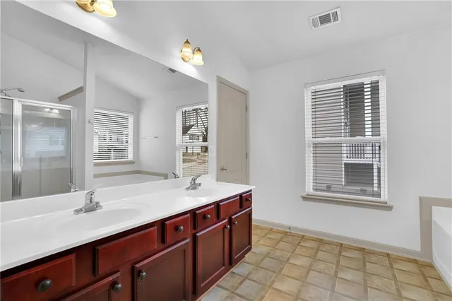 a bathroom with a sink a vanity and a bathtub