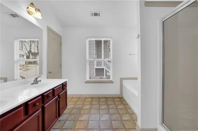 a bathroom with a bathtub and a shower