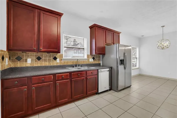 a kitchen with stainless steel appliances granite countertop a refrigerator and a sink
