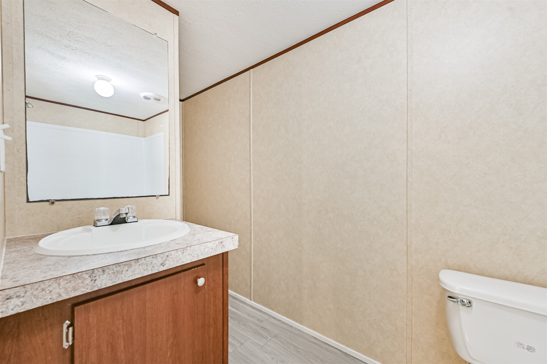 4702 10th Street Bacliff, TX 77518 - Photo 19 of 33 a bathroom with a sink and a mirror