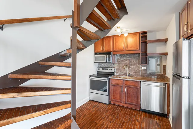 a kitchen with stainless steel appliances granite countertop a stove and a refrigerator