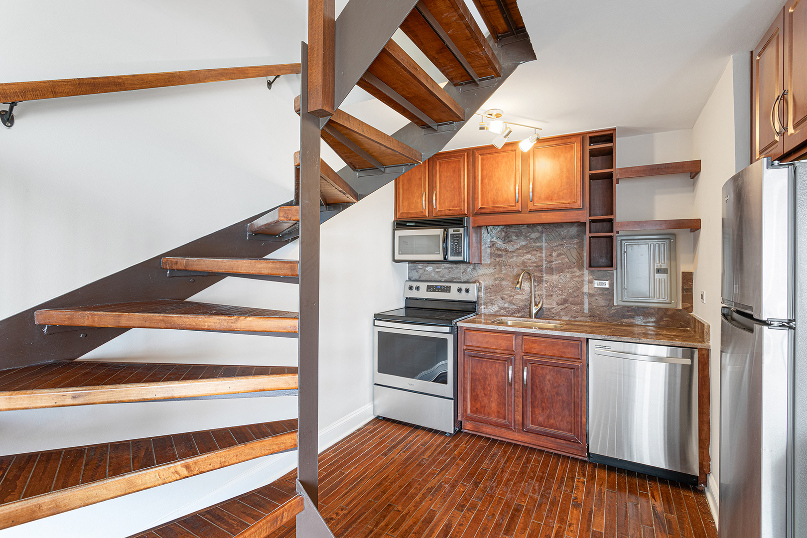 6166 North Sheridan Road, Unit 14F Chicago, IL 60660 - Photo 6 of 23 a kitchen with stainless steel appliances granite countertop a stove and a refrigerator