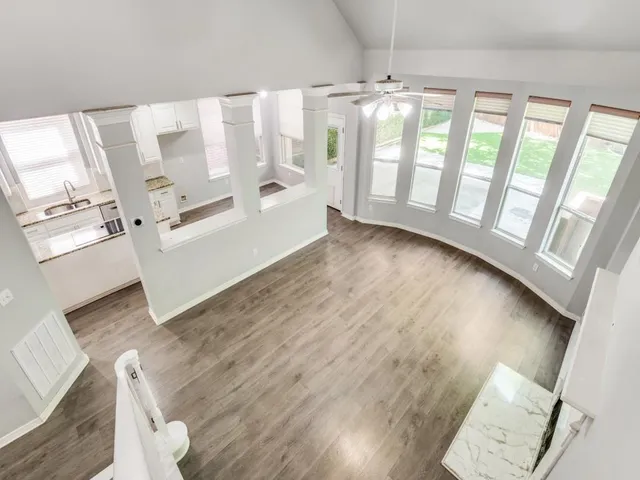 a view of a kitchen with wooden floor and electronic appliances