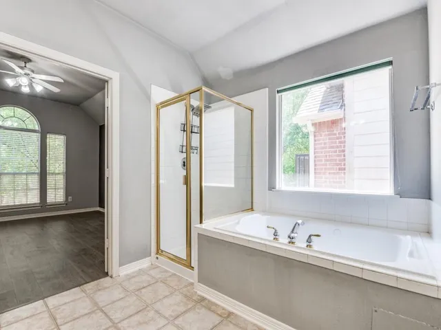 a bathroom with a bathtub and a shower