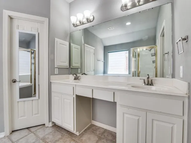 a bathroom with a sink double vanity and a mirror