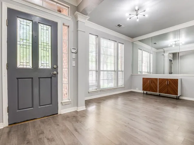 a view of a livingroom with furniture and chandelier fan