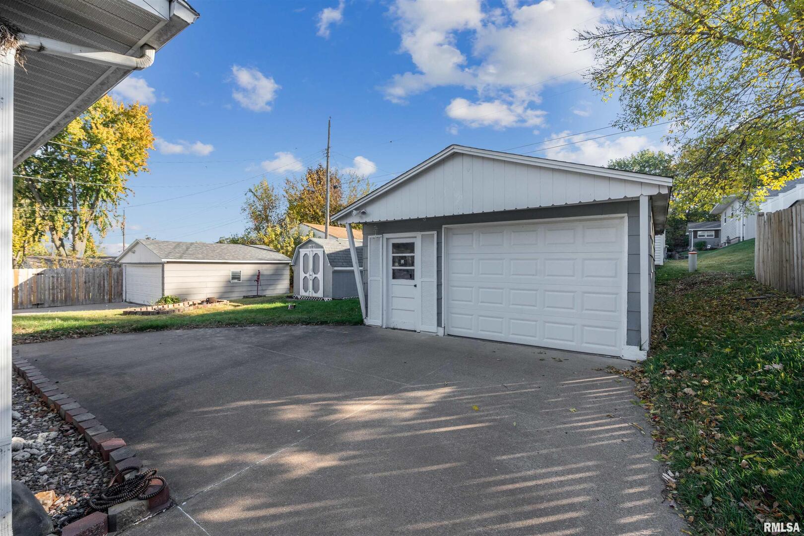 8101 8th Street West Rock Island, IL 61201 - Photo 24 of 25 a front view of a house with a yard and garage