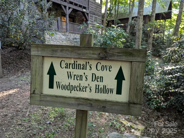 a view of small yard in front of house with wooden fence