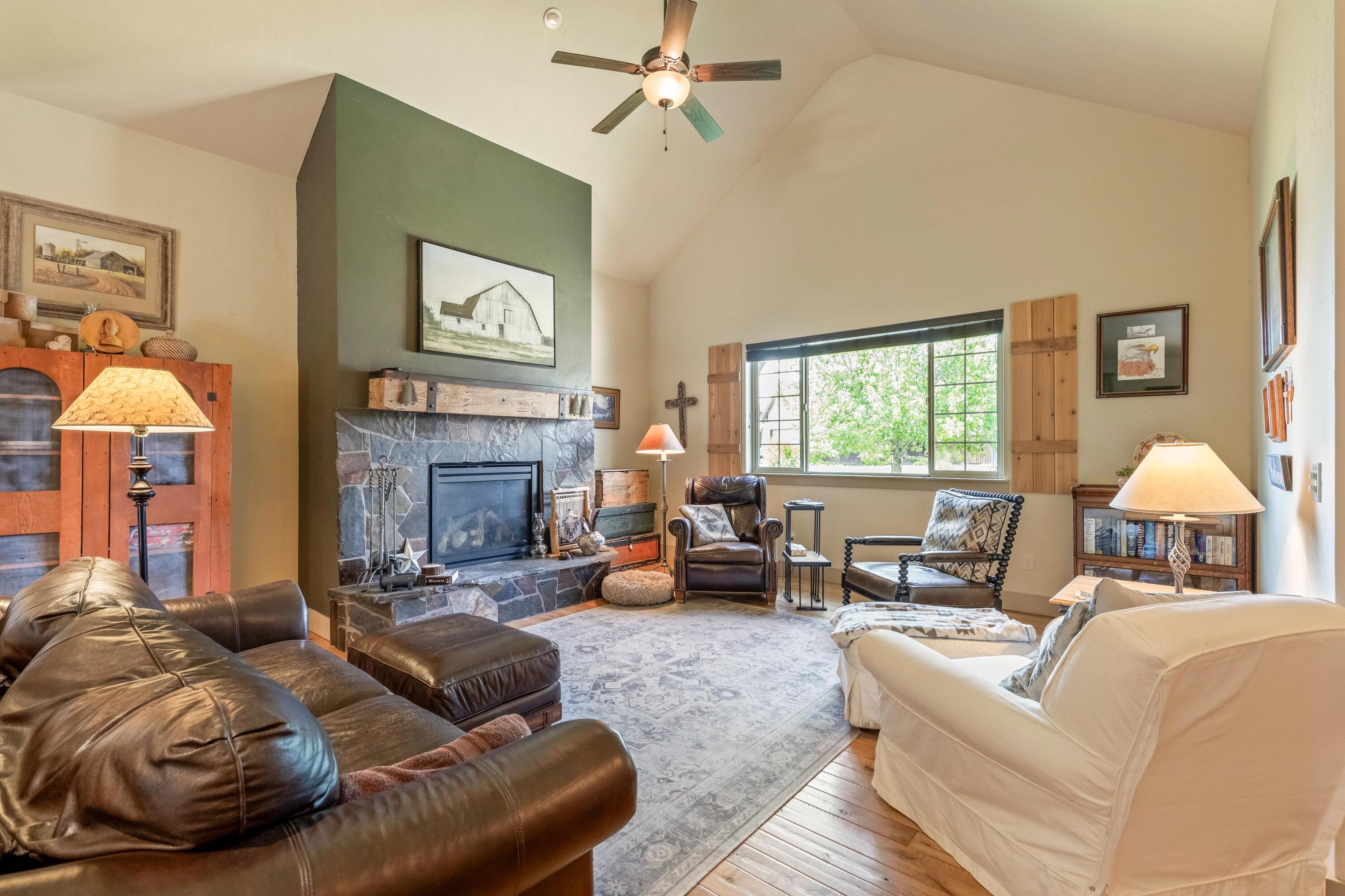 210 Northwest Saddle Ridge Loop Prineville, OR 97754 - Photo 5 of 38 a living room with furniture a fireplace and a window