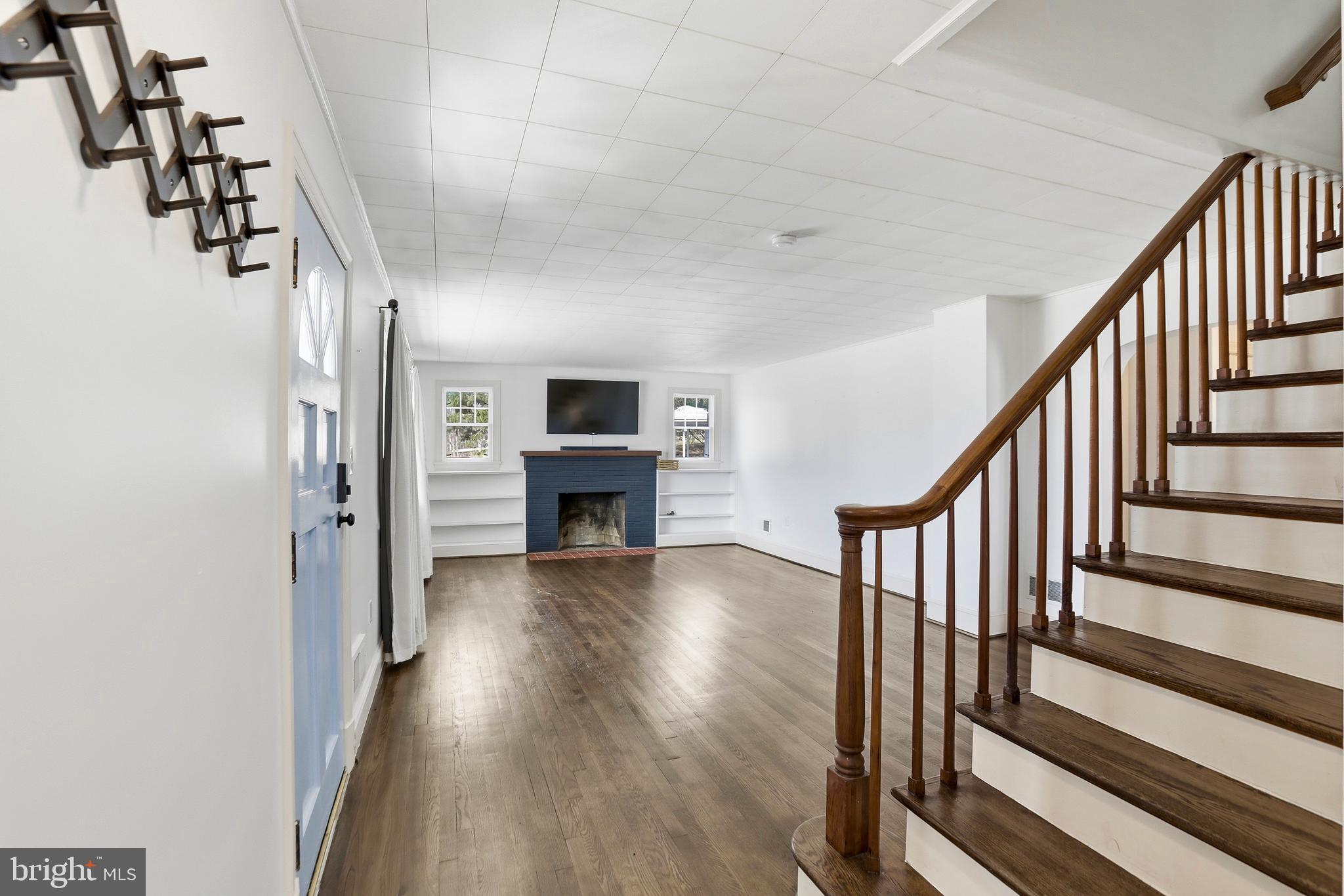 12242 Harpers Ferry Road Purcellville, VA 20132 - Photo 14 of 49 a view of main area wooden floor and staircase