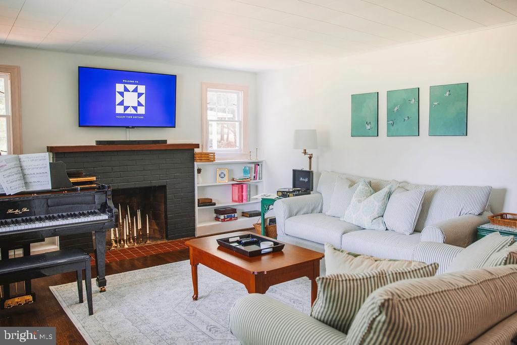 12242 Harpers Ferry Road Purcellville, VA 20132 - Photo 16 of 49 a living room with furniture and a fireplace