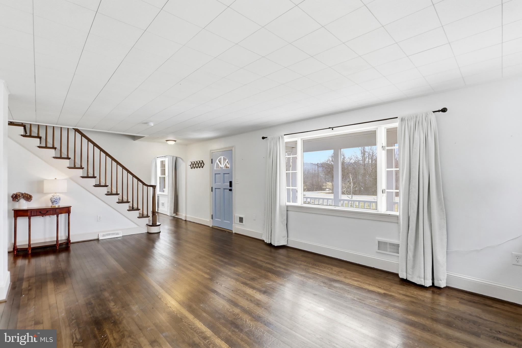 12242 Harpers Ferry Road Purcellville, VA 20132 - Photo 17 of 49 a view of an empty room with wooden floor and a window