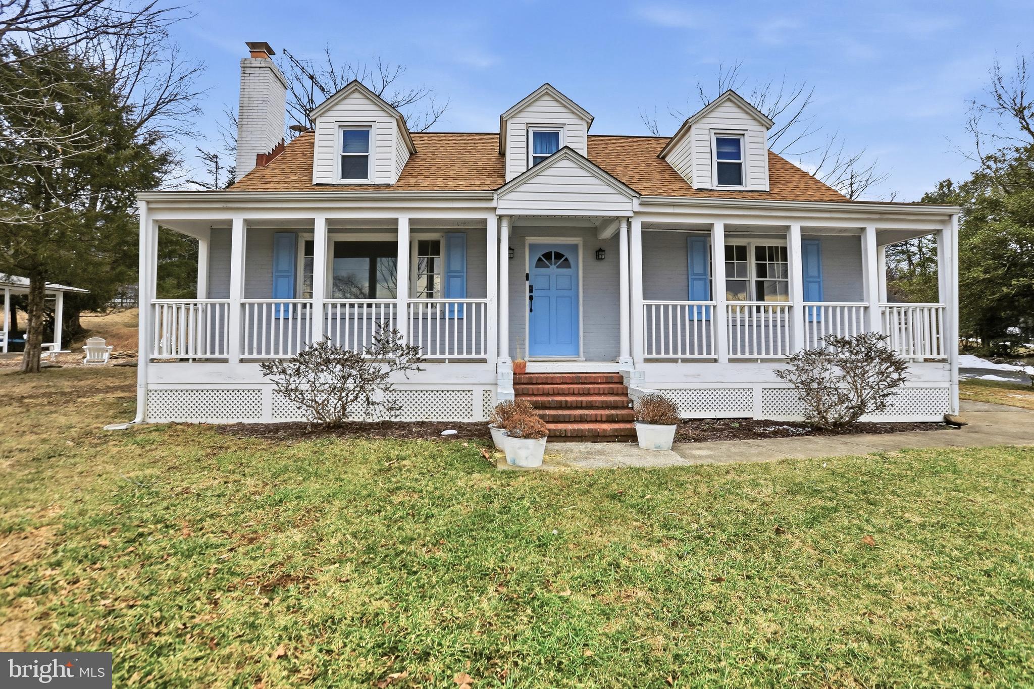 12242 Harpers Ferry Road Purcellville, VA 20132 - Photo 2 of 49 a front view of a house with garden